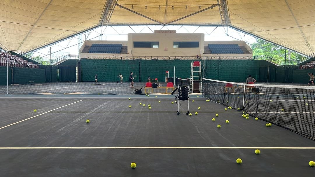 Covered tennis court with coaching equipment